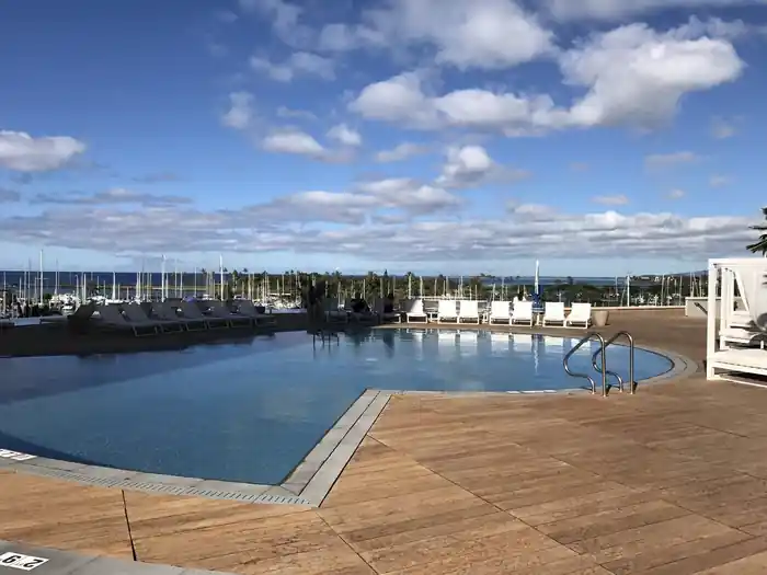 Renovated Hawaii Prince pool deck with a curved edge above the Ala Wai marina